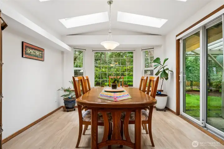 Bay windows fill the dining area with natural light, while the built-in bench provides additional seating and storage.