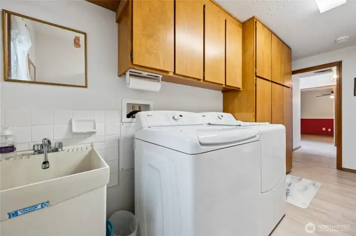 Laundry and mudroom combination with direct access to the garage, providing a practical everyday entry space.