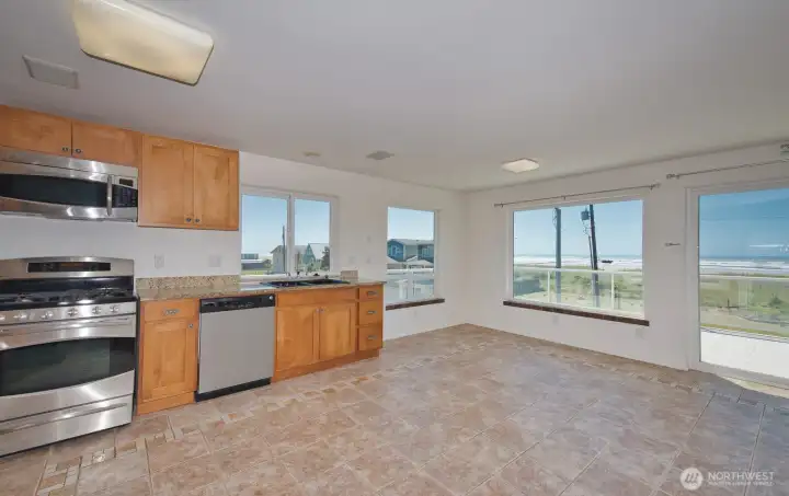 Kitchen and living area with ocean views and slider to deck