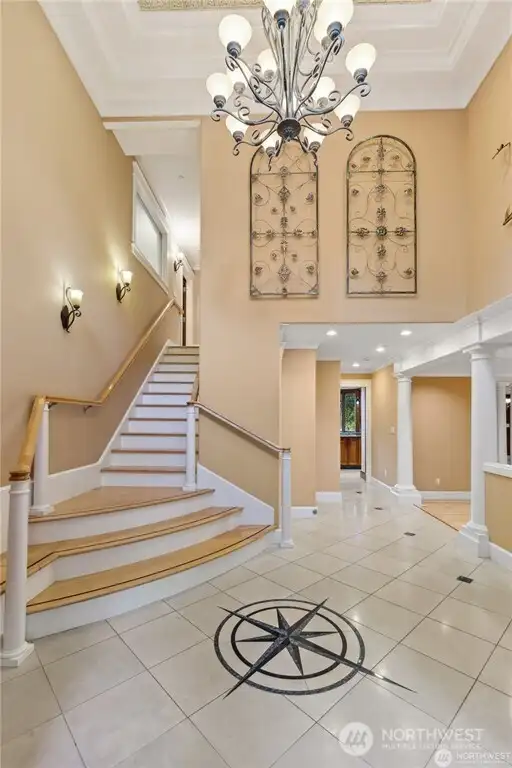 Dramatic Foyer accented with a Custom Designed Compass installed by Artisan Marble/Granite Expert. Coffered Ceiling with Traditional 1875 Style Stamped Tin Ceiling. Dramatic Foyer accented with a Custom Designed Compass installed by Artisan Marble/Granite Expert. Coffered Ceiling with Traditional 1875 Style Stamped Tin Ceiling.