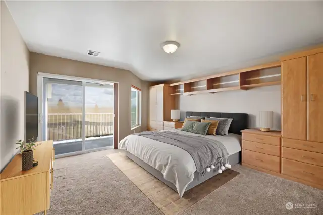 Primary suite with built-in storage, 2nd access to deck, 5 piece bathroom and walk-in closet with storage system.