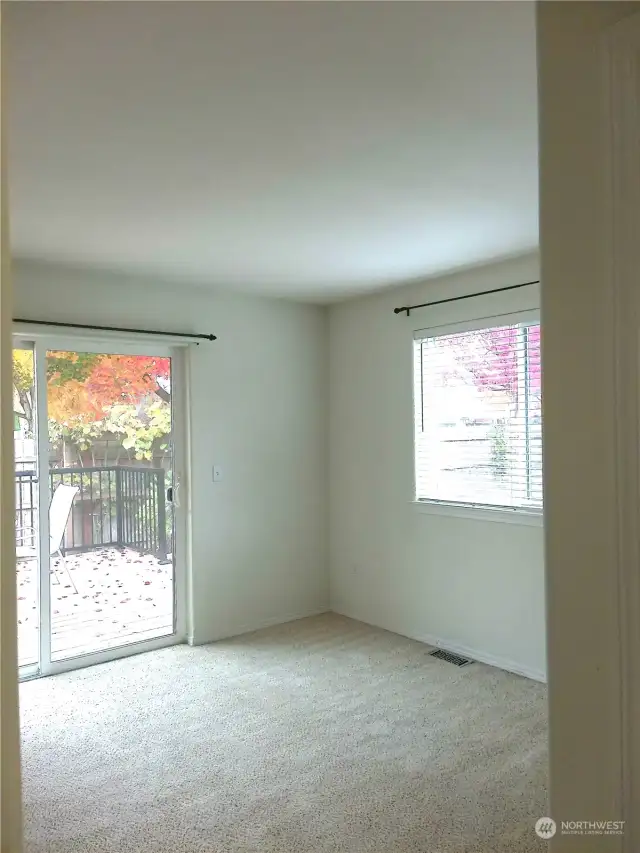 Primary bedroom with sliding glass door to the deck and yard