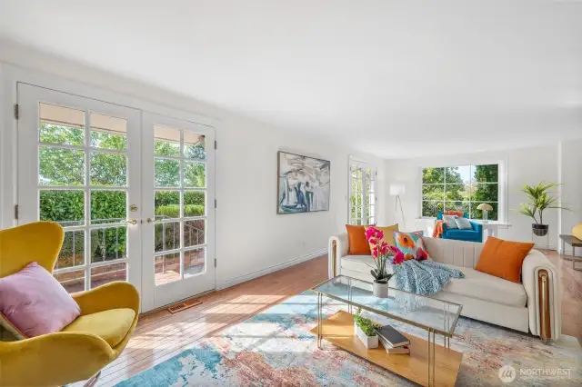 Light-filled living room with French doors leading to outdoor patio.