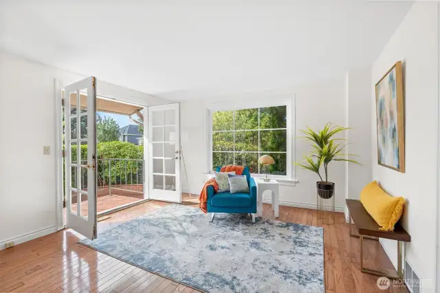 Light-filled living room with French doors leading to outdoor patio.