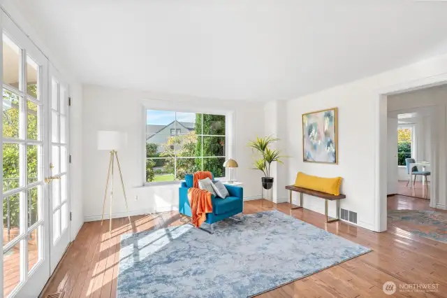 Light-filled living room with French doors leading to outdoor patio.