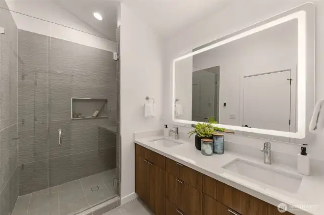 Primary Bathroom w/ Heated Floors and Backlit Mirror.