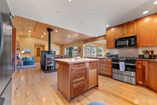 Kitchen, dining and living flow seamlessly together. Gorgeous soap stone woodstove adds ambiance and heat sink for the chilly winter days. Efficient forced air furnace with heat pump keeps the house evenly heated and warm! New dishwasher and garbage disposal in sink.