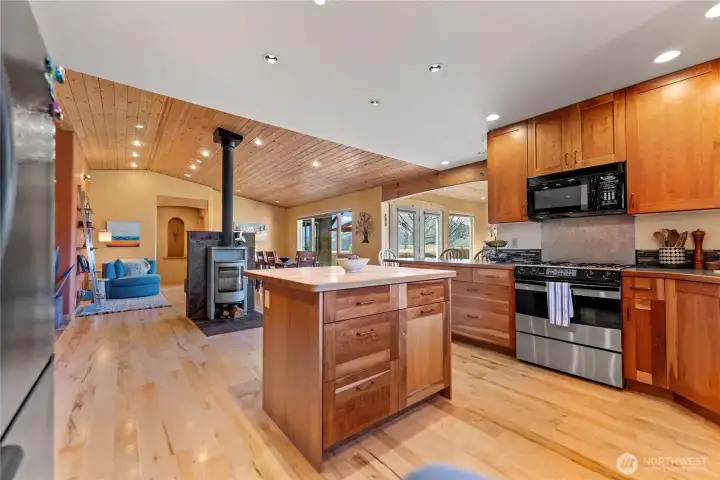 Kitchen, dining and living flow seamlessly together. Gorgeous soap stone woodstove adds ambiance and heat sink for the chilly winter days. Efficient forced air furnace with heat pump keeps the house evenly heated and warm! New dishwasher and garbage disposal in sink.