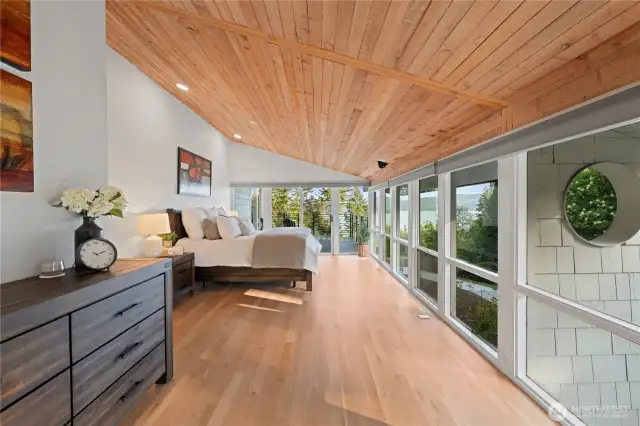 This view of the 1st primary suite shows how spacious it is. The bracket on the ceiling is a ceiling mount for a tv that was taken down for photos. TV and mount included.