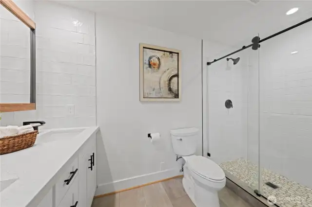 This is the 1st primary suite's bathroom, dual sinks, glass shower door, beautiful!