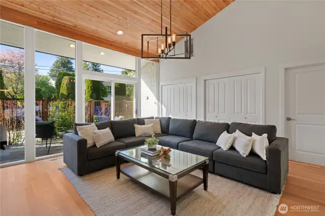 This is the family room. It is on the same wing as the 1st primary suite and 2 additional bedrooms and guest bathroom. The slider accesses the private patio.
