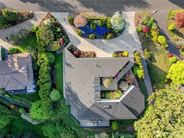 This arial shows the new roof, custom footprint of the house and the circular driveway.