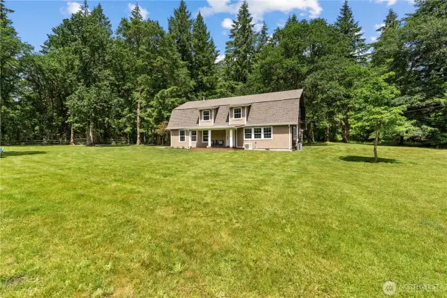 Full-Front View of Home Surrounded by Open Green Space  This clear, full-frontal view of the 2-story cabin-style home captures its balanced blend of rustic charm & modern functionality. Nestled against a backdrop of towering evergreens, the home sits centered in a wide open lawn—offering incredible curb appeal, privacy & usable space. Whether you envision hosting summer gatherings or simply enjoying the peace of nature, this Rochester retreat provides the space & serenity that Pacific Northwest buyers are searching for.
