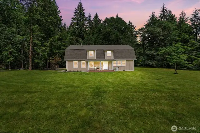 Twilight Glow – Peaceful Country Living at Dusk  As the sun sets behind the trees, the warm interior lights of this cabin-style home cast a welcoming glow across the manicured lawn. This stunning twilight image showcases the home's inviting presence & secluded setting on nearly 10 acres of private land in Rochester, WA. Surrounded by forest & peace, this photo captures the tranquil lifestyle that awaits—where every evening feels like a retreat. A perfect blend of comfort, nature & timeless Pacific Northwest charm.