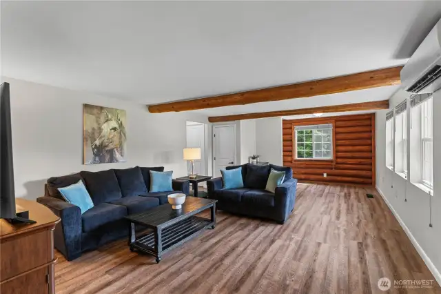 Bright Living Room with Log Cabin Accent & Beam Ceilings
