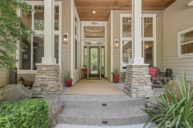 Tongue and groove soffits, stone accents on the pillars and the extra tall front door complete this polished entry!