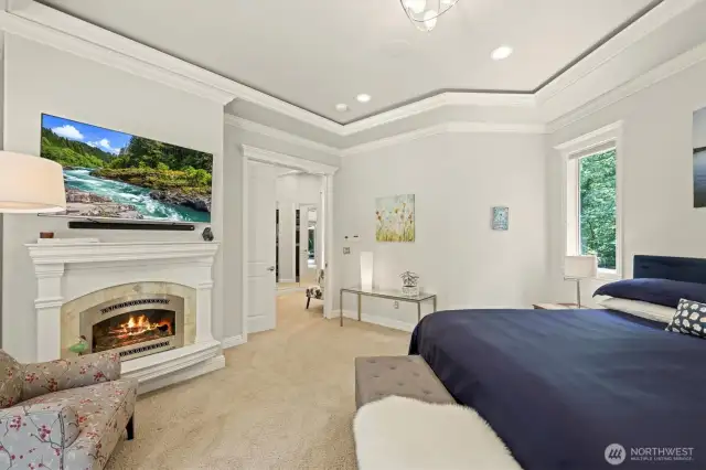 How could you not relax in this primary bedroom with gas fireplace and wiring for rope lighting in the coffered ceiling?