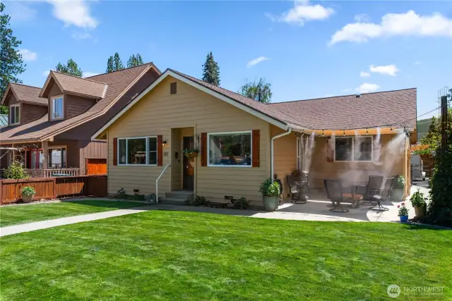 Front of house view with misters turned on over front patio area.  Comfortable 4 season living!