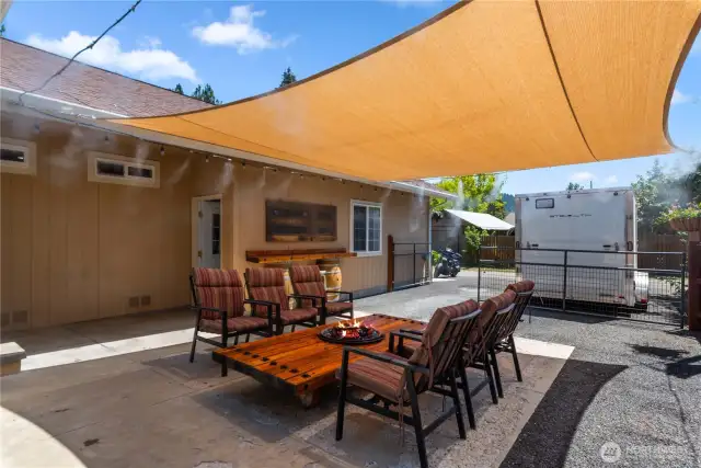 Rear outdoor patio area, shade sail and misting system stay with the house!