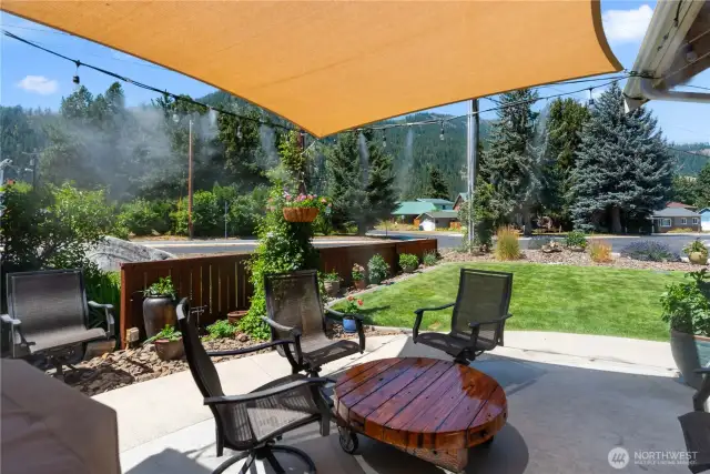 Front patio area with misting system and shade sail.  Misting system and shade sail stay with house.