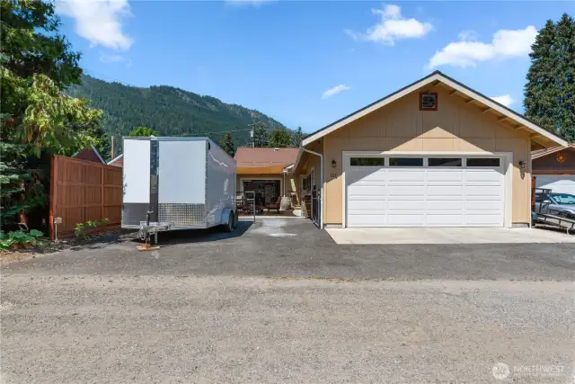 Rear of view from alley. Trailer is parked in driveway leading to additional single car garage.