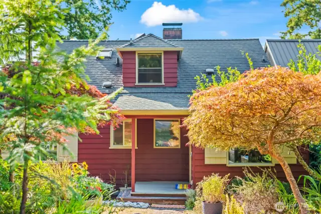 Charming and colorful, the front of the home is inviting and peaceful here on this 1/2 acre lot!