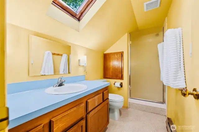 This 3/4 upper bath is super bright with the large skylight above!