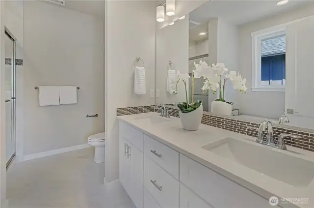 A primary bath area with easy to clean, durable surfaces, ample cabinetry and storage, a large, tile surround shower plus a free standing bathtub.