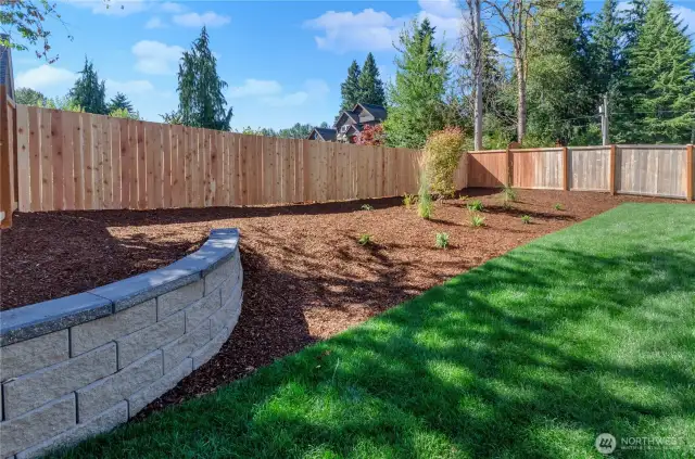 Beautiful, fully landscaped and irrigated rear yard with sod grass area and stone shelf.  Perfect for outdoor enjoyment!