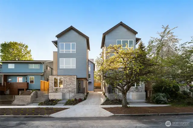 Street view of the community, showcasing multiple home styles unified by contemporary design.