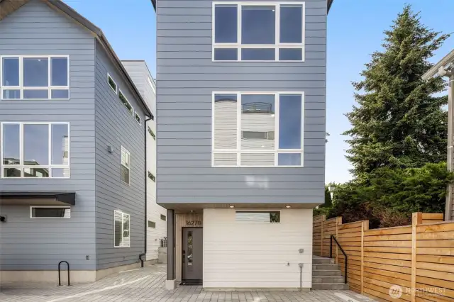 Side yard with fresh landscaping and room to garden, relax, or entertain.