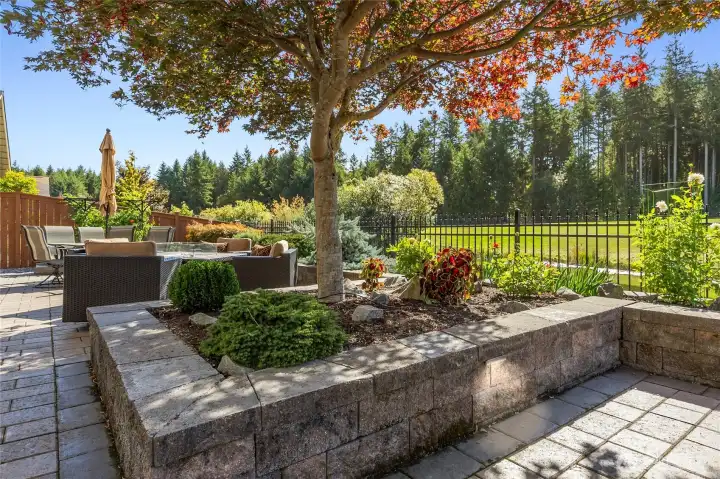 Professional landscaping with custom accent lighting in retaining walls and drip system throughout.
