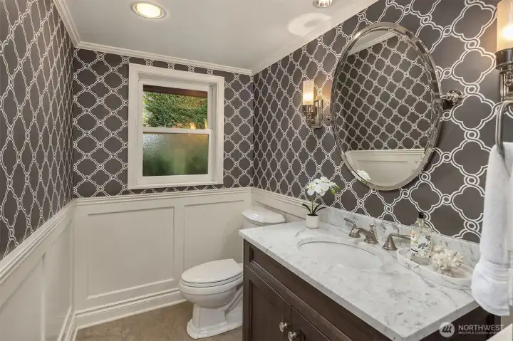 Powder room. Designer wallpaper makes a fun statement. This is located in the hall between the living room and kitchen/family room.