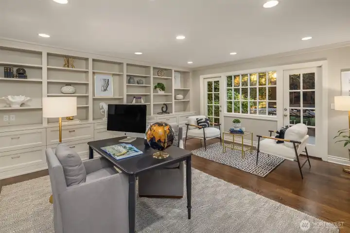 Main floor den/office.  Doors out to the back yard and plenty of great storage for your own library or office.