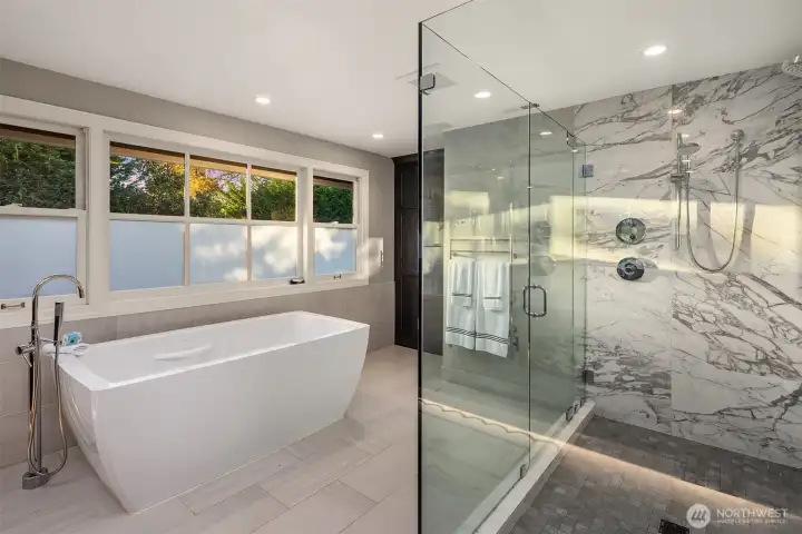 Soaking tub and large glass shower.