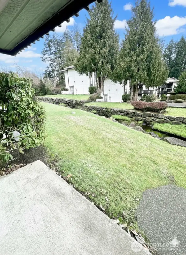 Serene stream flows in common area near patio
