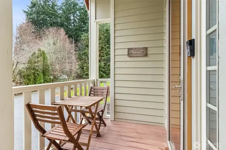 The covered front porch is ready for a couple chairs, a seasonal wreath moment, and that first cup of coffee before the day gets busy. There’s a glass storm door here too, so you can swing open the main door and turn the entry into a light-filled window looking out over the porch. You’ll also spot the video doorbell already in place, plus a full security system wired to all ground level doors and windows with both motion and audible features, so peace of mind is already handled.