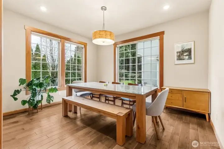 This dining room shows up bright and ready, with oversized windows pulling in sunlight all day and those thick maple hardwood floors continuing to impress. The drum style chandelier keeps it current without being flashy, and the proportions here give you options. Set it up for dinners, holidays, and hosting, or pivot it into a den, library, or second living space if that fits your life better. The seller is also offering to leave the dining bench, which is one less thing to shop for and honestly a great anchor piece for the room.