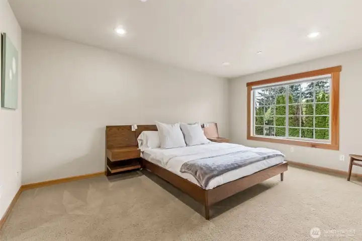 This primary keeps it calm and easy, with a big picture window pulling in soft light and that neutral latte tone carpet fresh and ready for whatever direction you take it. At roughly 12’ x 16’ , there’s plenty of room for a king setup plus nightstands, reading chair, or even a little lounge moment or another remote working zone if needed.