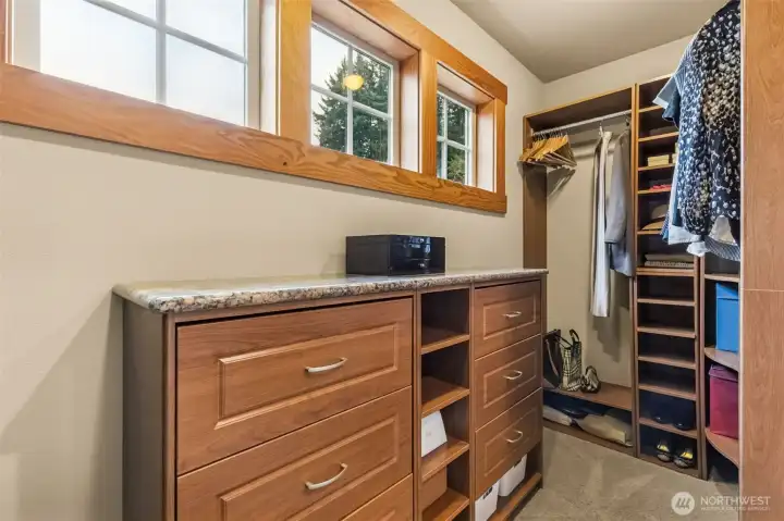 A walk-in closet that actually lives up to the name. Those high-set windows let the light pour in while keeping things private, and they free up the walls for all the custom built-ins that make staying organized feel a little less like a chore. There’s space to spread out, room to see everything at a glance, and enough structure here to keep it looking pulled together even on a busy morning.