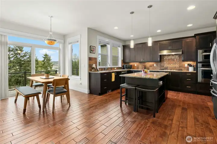 Casual eating is part of the kitchen. Notice the hardwood floors.