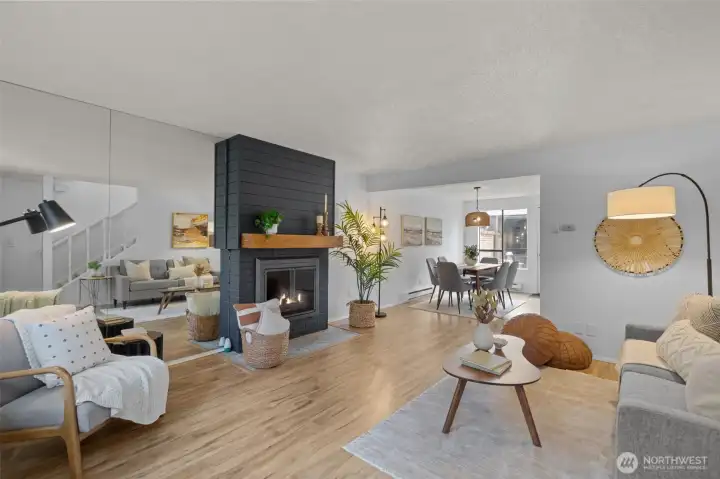 Move-in ready home featuring a bright, open-concept layout and stylish modern finishes throughout. The spacious living area is anchored by a sleek, contemporary fireplace with custom surround, creating a warm and inviting focal point perfect for relaxing or entertaining.