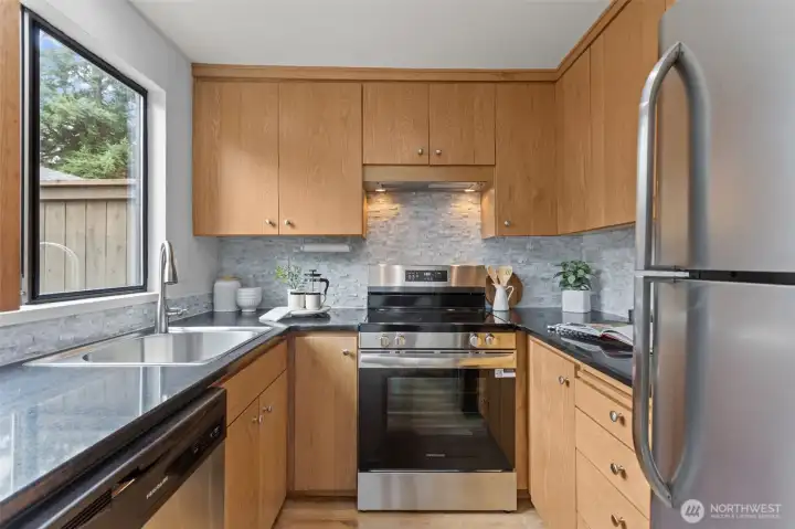 Updated counters and backsplash make this kitchen refreshing and inviting.
