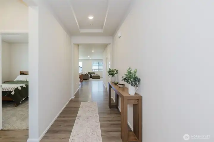 To the left off the foyer are the secondary bedrooms and the guest bathroom. Straight ahead is the large, open living area. To the left off the foyer are the secondary bedrooms and the guest bathroom. Straight ahead is the large, open living area.