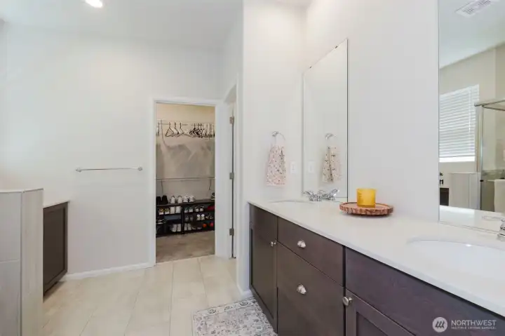 Primary bath includes large vanity with double sinks, shower, water closet, and extra storage cabinetry for linens. Primary bath includes large vanity with double sinks, shower, water closet, and extra storage cabinetry for linens.