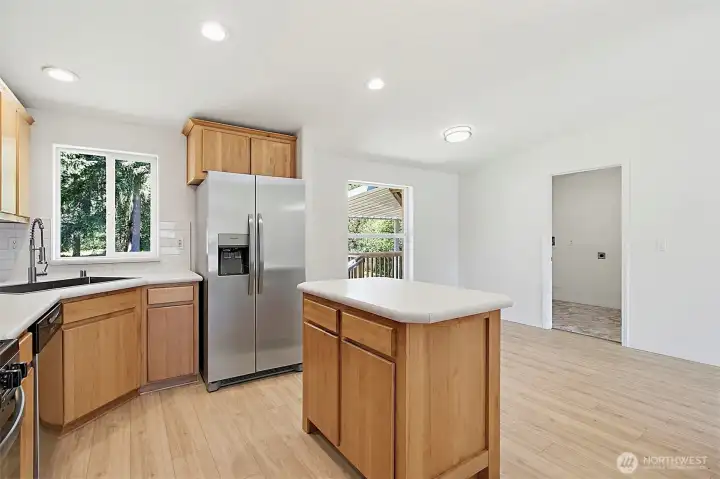 Kitchen with island and new stainless appliances. Kitchen with island and new stainless appliances.