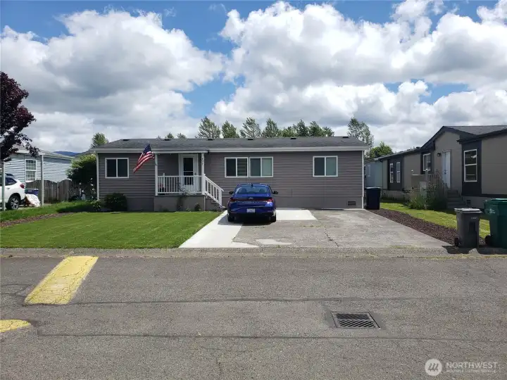 Front of the Home with a Covered Front Porch and enough Parking space for 4 Vehicles.