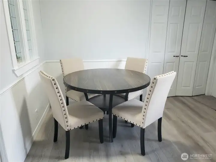 Nice Dining Room Area off the Kitchen showing New Utility Room White 6 Panel Doors, Wayne's Cotting, Window Trim, and Vinyl Plank Flooring.