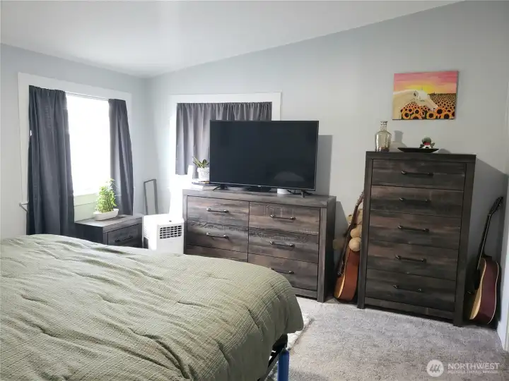 A Picture of the Large Primary Master Bedroom showing New Interior Paint, White Painted Trim and the New Carpet Flooring.