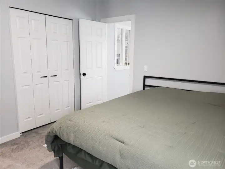 A Different Picture of the Large Primary Master Bedroom showing New 6 Panel Doors, Interior Paint, White Painted Trim and the New Carpet Flooring Looking at the Walk In Closet. A Different Picture of the Large Primary Master Bedroom showing New 6 Panel Doors, Interior Paint, White Painted Trim and the New Carpet Flooring Looking at the Walk In Closet.